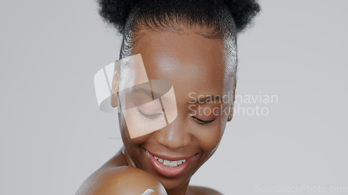 Image of Woman, face and body for cream or moisturizer, cosmetic and beauty with smile in studio. African model, glow and dermatology with lotion for skincare aesthetic and skin health with grey background