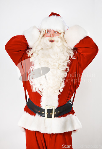 Image of Santa claus, hand and head for mistake forgot for holidays, Christmas celebration or shock. Male person, costume suit and hand gesture for problem stress, present gifts on white studio background