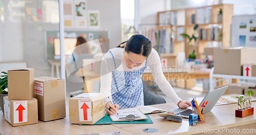 Image of Ecommerce, Asian woman with checklist and boxes at laptop, reading sales or inventory at fashion startup. Online shopping, delivery and small business owner, stock list for web shop package checking.