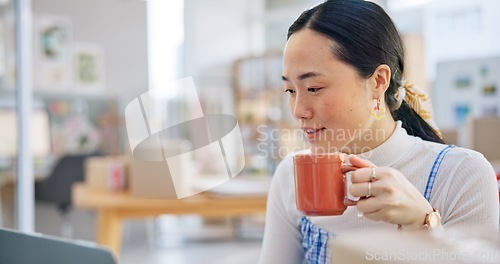 Image of Ecommerce, Asian woman at laptop with coffee and boxes, checking sales email or work at fashion startup. Online shopping, distribution and small business owner with drink, computer and review at desk