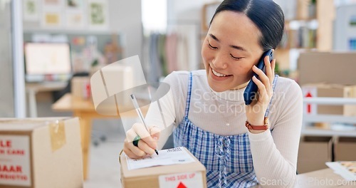 Image of Ecommerce, Asian woman with phone call and package, writing and checking sales and work at fashion startup. Online shopping, boxes and small business owner with smartphone, orders and networking.