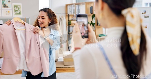 Image of Fashion influencer, cellphone and women live streaming clothes presentation, style review or mobile app broadcast. Phone, content creator team and small business owner teamwork on retail commercial