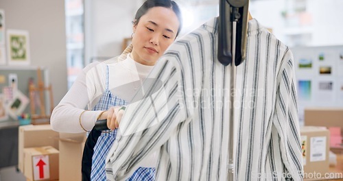 Image of Asian woman, fashion designer and steam clothing in logistics, small business or quality service at boutique. Female person in dry cleaning, retail store or product preparation for delivery at shop