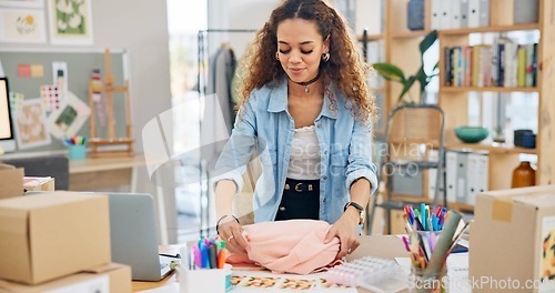 Image of Small business, clothes and a woman packing an order or logistics for fashion delivery in store. Young entrepreneur person or startup company owner for e commerce, parcel or packaging of product