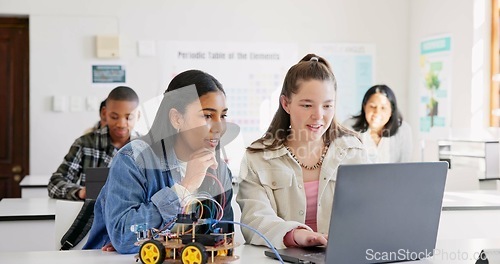 Image of Robotics, education and children with laptop at school learning coding, robot or car toy. Girl students in classroom for technology, electronics or science for development, innovation or teamwork