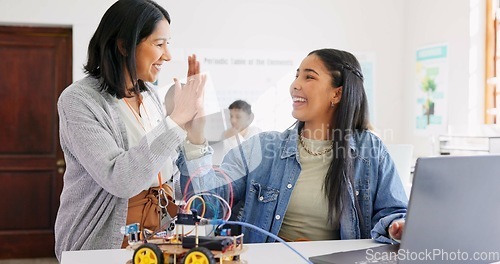 Image of Learning, teacher and high five of student on laptop in classroom, achievement or goal in robotics. Engineering, computer and teenager celebrate success, happy girl and study education at high school