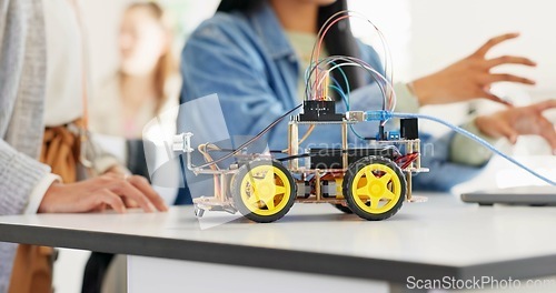 Image of Hands, robotics classroom and students at school, learning or discussion for future development. Group, people and education with electronics, transportation or energy for moving, building or talking