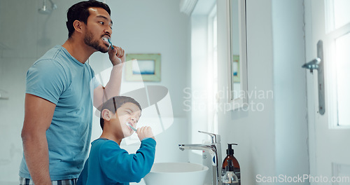 Image of Father, child and brushing teeth in family home bathroom while learning or teaching dental hygiene. A man and kid with toothbrush and toothpaste for health, cleaning mouth and wellness at mirror