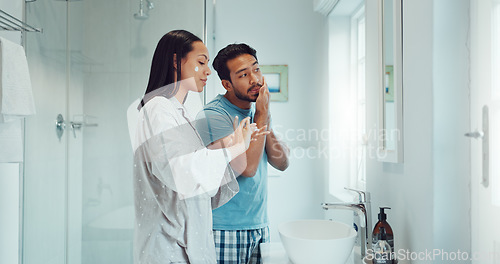 Image of Couple, bathroom and cleaning face with cream, skincare and comic joke with laughing, serum or product. Man, woman and funny with facial oil moisturizer for beauty, wellness or self care in apartment