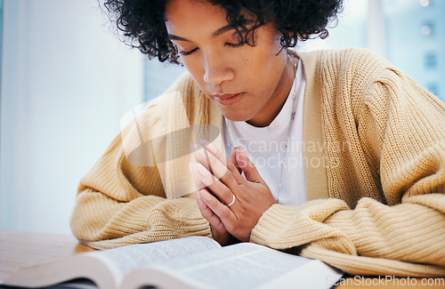 Image of Bible, praying and woman in home for religion, Christian worship or reading to study. Person, holy book and meditation at desk for God, Jesus Christ and faith in spiritual gospel, praise and hope