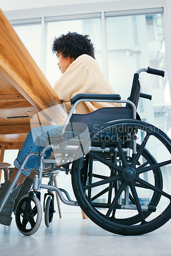 Image of Office, desk and worker in wheelchair for working on project, planning and report in inclusive workplace. Company, professional and closeup of person with disability for job, career and opportunity