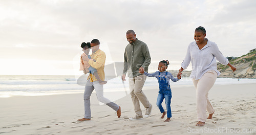 Image of Happy, walking and a black family at the beach, holding hands and talking on a holiday. Sunset, conversation and grandparents, father and children on a walk by the sea during a vacation for travel