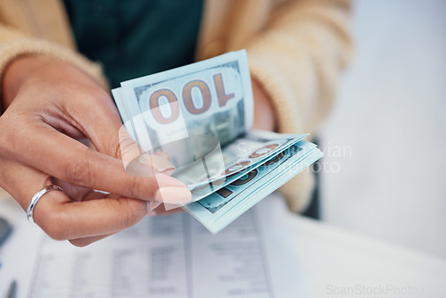 Image of Hands, finance and a business person counting money closeup in the office of a bank for accounting. Cash, budget and economy with a financial advisor closeup in the workplace for investment growth