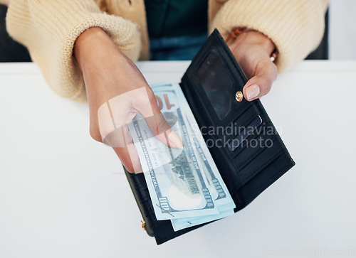 Image of Woman, hands and wallet with money for savings, investment or payment on counter at checkout. Top view or closeup of female person with cash, bills or paper notes for finance, purchase or shopping
