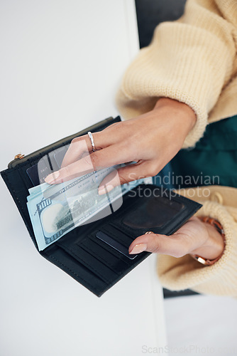 Image of Person, hands and wallet with money for investment, savings or payment on counter at checkout. Top view or closeup of female person with cash, bills or paper notes for finance, purchase or shopping