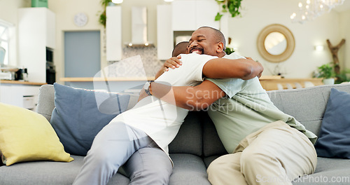 Image of Hug, talking and a father and son on the sofa for a visit, bonding or gratitude. Happy, house and an African dad embracing an adult man for greeting, love or care during a conversation on the couch