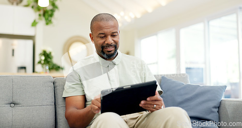 Image of Technology, mature man with tablet and in living room of his home happy for social media. Online communication or networking, connectivity or leisure and black male person on couch with smile