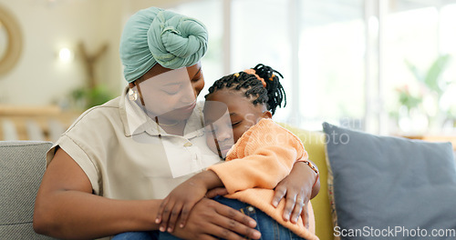 Image of Mother hug sleeping child on couch for love, care or holding for comfort in lounge at home. Black woman, happy mom and kissing girl kid on lap for nap, rest or support to relax on sofa in living room