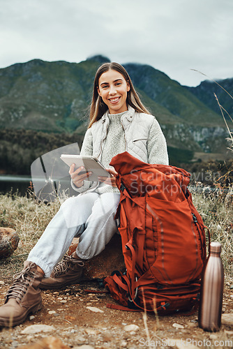 Image of Tablet, backpack and woman trekking in nature on mountain for adventure, weekend trip or vacation. Digital technology, bag and female person from Canada network on social media and hiking in forest.