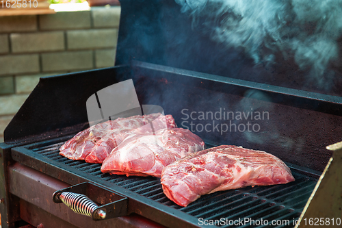 Image of Pork meat steaks on the grill