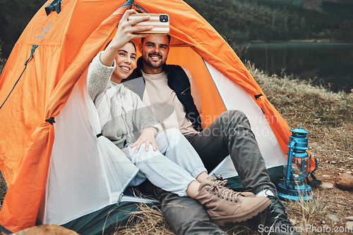 Image of Couple, tent and camping selfie with smile, memory and holiday, web blog and morning in countryside. Man, woman and relax with vacation, social media post and adventure with love, outdoor and freedom