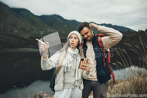Image of Hiking, stress and lost couple with a phone in nature for direction, map or navigation with anxiety. Backpacking, travel and people with smartphone app for location search or navigation to campsite