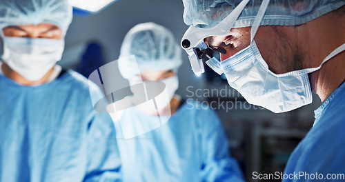 Image of Surgery, hospital and doctor with face mask for operation, medical emergency and service in theater. Healthcare, procedure and closeup of surgeon with light for patient injury, wellness and accident