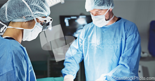 Image of Doctors, team and surgery in theater with medical support for healthcare, safety and operation room at hospital. Surgeon, medicine and teamwork or collaboration with tools for cardiology or emergency