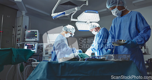 Image of Doctors, team and surgery in theater with medical support for healthcare, safety and operation room at hospital. Surgeon, medicine and teamwork or collaboration with tools for cardiology or emergency