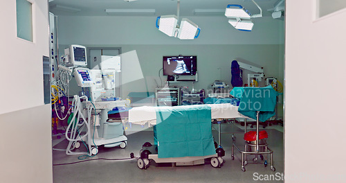 Image of Empty hospital, medical and operation room for emergency service, healing patient and interior. Healthcare backgrounds, surgery theatre and bed with machine tools for wellness, medicine and treatment