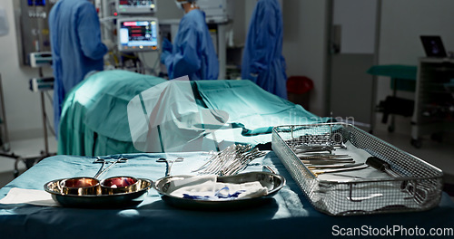 Image of Surgery, healthcare and tools in operation theatre, help in medicine with treatment and closeup of equipment on table. Metal, medical and surgical instrument with doctor people at hospital for health