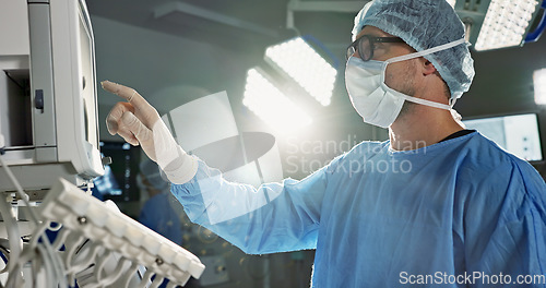 Image of Team, surgeon and press monitor in hospital, clinic and operation theater. ECG, doctor and medical professional on tech for heart rate monitor, cardiology and man on electrocardiogram on lens flare