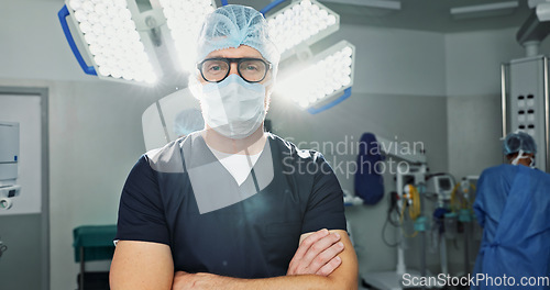 Image of Surgeon, doctor and man in portrait with arms crossed, healthcare and confidence in operation theater for medical procedure. Surgery, health professional and help in hospital, expert with face mask