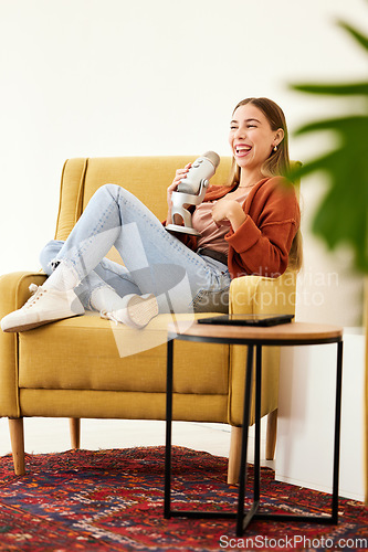 Image of Microphone, smile and woman hosting a podcast on a chair by a wall in her modern home. Radio, broadcast and happy young female person hosting a journalism talk show in a recording space at her house.