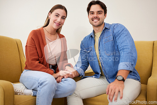 Image of Couple, holding hands and portrait on sofa, home and care with love, bonding and kindness in relationship. Man, woman together and support with empathy, trust and respect with solidarity in house