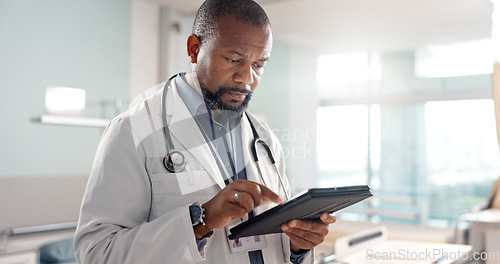 Image of Healthcare, typing and a black man or doctor with a tablet for a medical app or communication. Mature, reading email and an African surgeon with technology for results, information or surgery advice