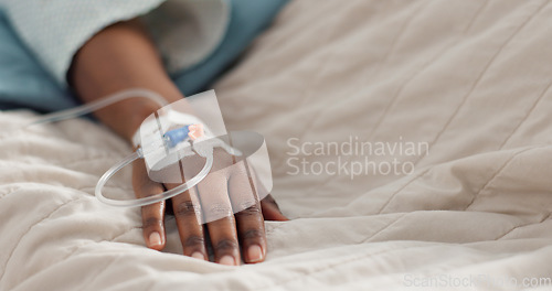 Image of Person hand, bed and drip in closeup, clinic or treatment for hydration, liquid or supplement. Patient, healthcare and wellness with blood transfusion, anesthesia or pharma drugs for pain in hospital