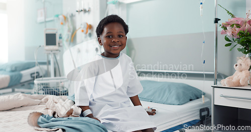 Image of Sick African boy child, hospital and bed with face, smile and rest for recovery from surgery, treatment or healthcare. Patient kid, happy and portrait to relax, sitting and clinic for rehabilitation