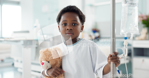 Image of African child, sick in hospital and teddy bear for healthcare, wellness or treatment on iv drip. Portrait, serious and face of kid in pediatric clinic with toys for recovery from surgery or healing