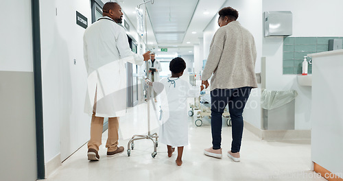 Image of Hospital, child and doctor while walking, medical and checkup with drip, healthcare and medicine. Hospitalisation, patient and care with help, treatment and diagnosis for health, wellness and virus