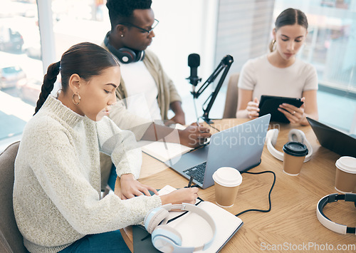 Image of Influencer, people and technology with teamwork for planning, podcast and content creation with laptop or tablet. Talk show, man and women in studio with headphones for collaboration with broadcast