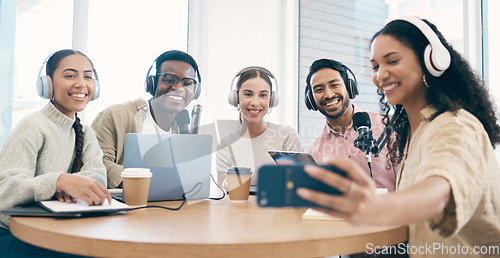 Image of Podcast, smile and group selfie of friends together bonding, live streaming and people recording broadcast in studio. Happy team of radio hosts take picture at table for social media or collaboration