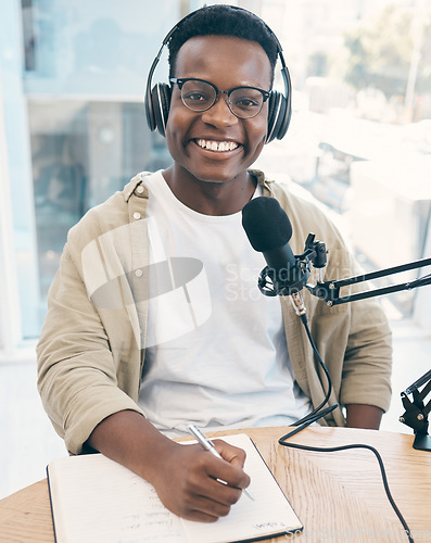 Image of Portrait, podcast and black man with a notebook, microphone and smile with news broadcasting. Face, African person and radio presenter with tech, share information and writing with content creator