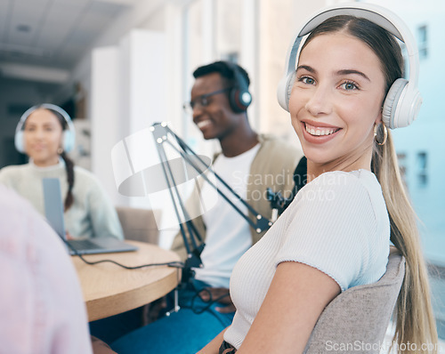 Image of Radio, broadcast and portrait of woman in office with people recording, audio or streaming conversation. Podcast, hosting and presenter with headphones, microphone and happy group broadcasting news