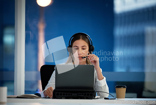 Image of Business woman, call center and computer for communication, technical support and information technology advice at night. Professional agent, consultant or advisor speaking on laptop at tech company