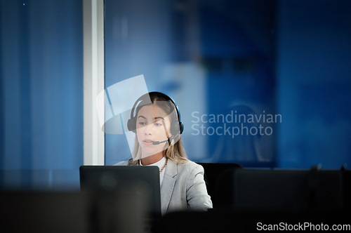 Image of Business woman, call center and laptop for communication, technical support and information technology advice at night. Professional agent, consultant or advisor speaking on computer at tech company