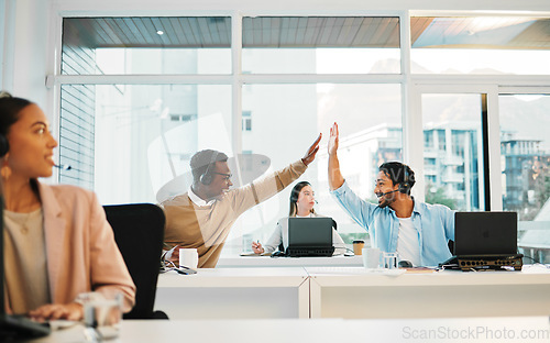 Image of Happy business people, call center and high five in teamwork, winning or promotion together at office. Businessman touching hands in customer service, telemarketing or success for contact us or sale