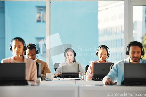 Image of Woman, call center team and consulting at laptop in telemarketing, customer service or IT support in coworking agency. CRM group at computer for online questions, telecom advisory or FAQ at help desk
