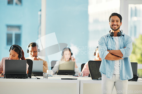 Image of Happy asian man, portrait and call center professional in confidence, customer service or leadership at office. Male person, consultant or agent manager smile with arms crossed in contact us or help