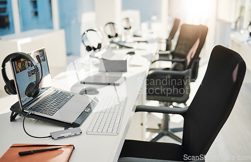 Image of Empty office, call center and headphones with laptop, chair and furniture for telemarketing with voip tech. Help desk, computer and customer service with contact us, technical support or consulting